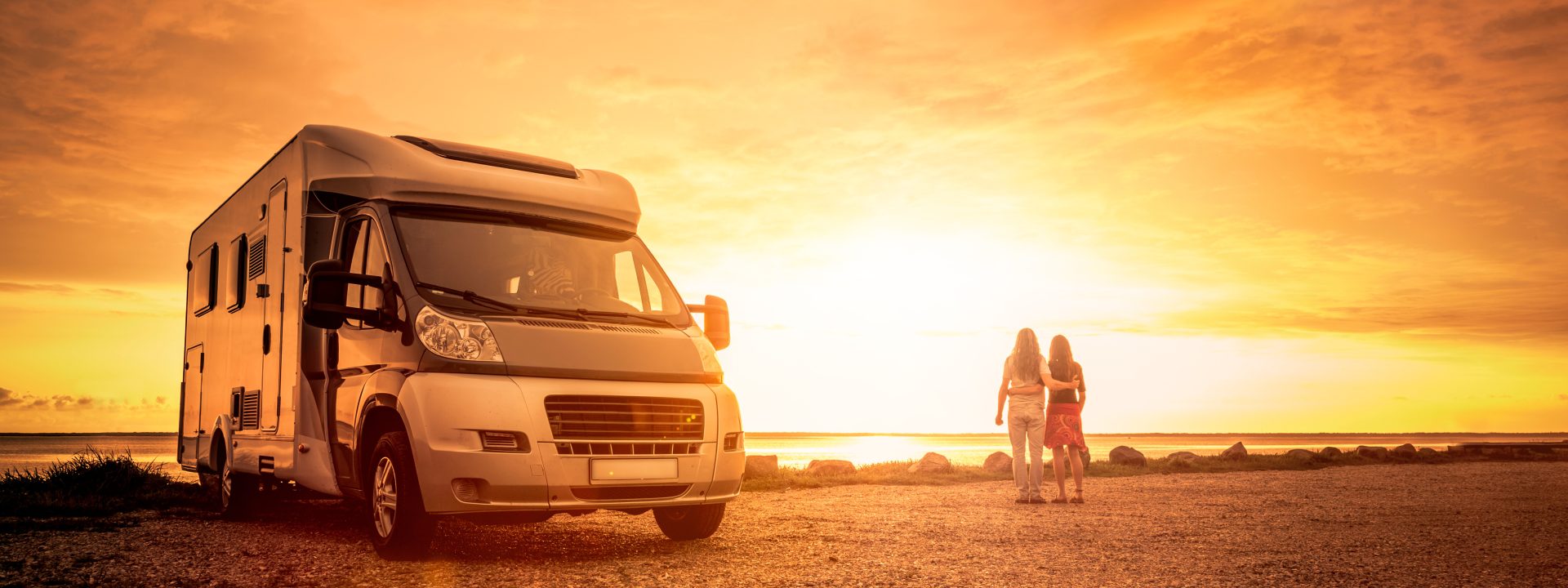 Bobil i solnedgang ved sjøen